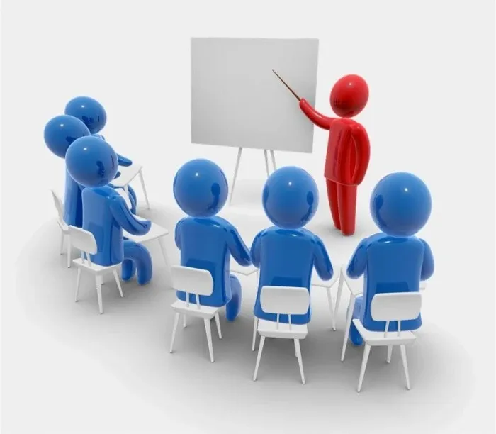 
Trainer presenting to a group of people in a classroom setting