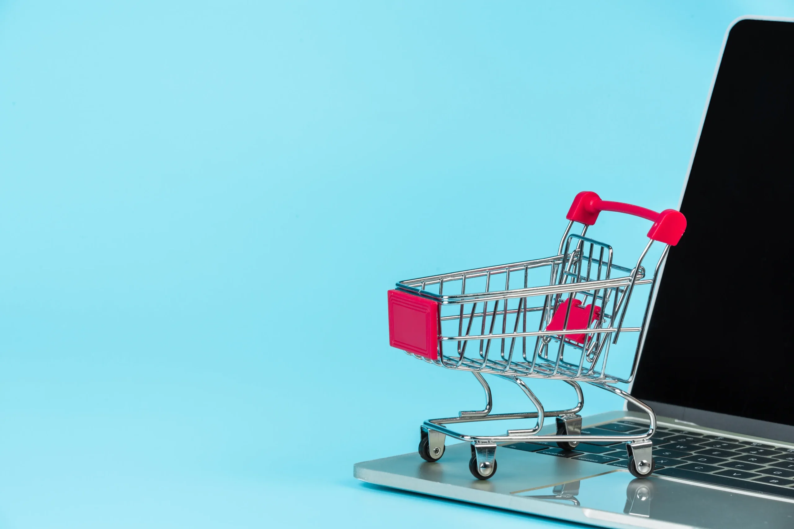 cart placed on top of a laptop representing ecommerce business