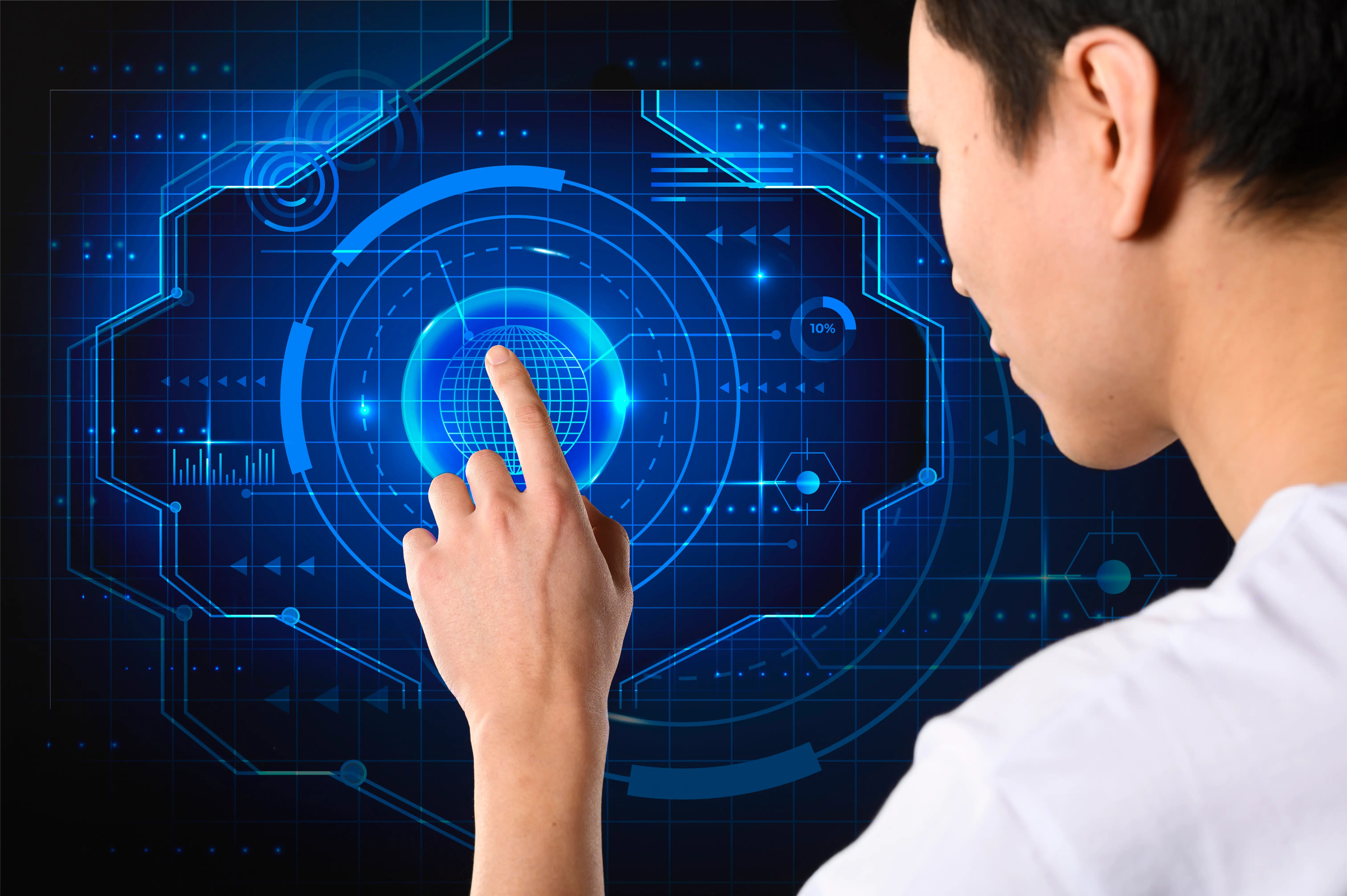 Person interacting with futuristic touchscreen interface with digital graphs and elements